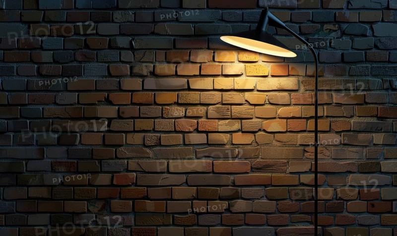 A contemporary adjustable floor lamp casts a warm glow on a brick wall, with distinct shadows AI generated