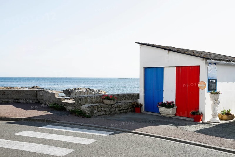 Garage painted in French national colours by the sea, Guilvinec, Finistere, Brittany, France, Europe