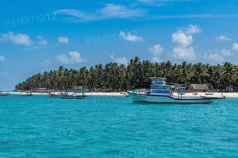 Little boats before a palm fringed white sand beach, Agatti Island, Lakshadweep archipelago, Union territory of India