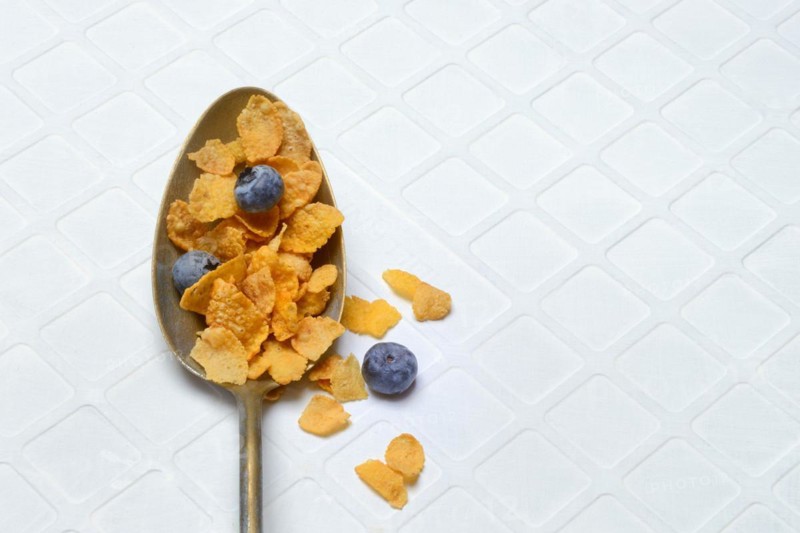 Cornflakes and blueberries in spoon, Breakfast
