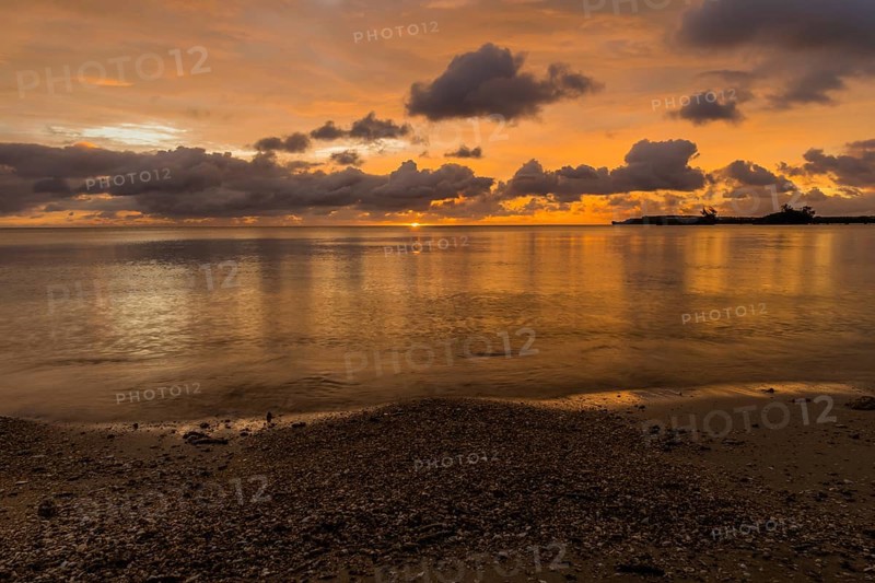 Beautiful sunset over ocean water taken from a beach in Guam