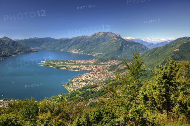 Panoramic View over an Alpine Lake Maggiore with mountain and Cityscape in a Sunny Summer Day over Locarno, Ticino, Switzerland, Europe