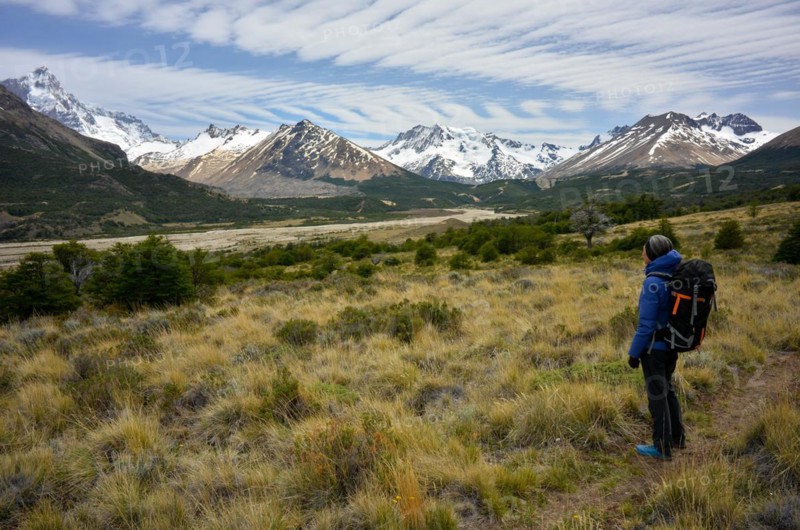 Hiker enjoying the view of the mountains and glaciers of the Patagonian Andes with Monte San Lorenzo, Perito Moreno National Park, Patagonia, Argentina, South America
