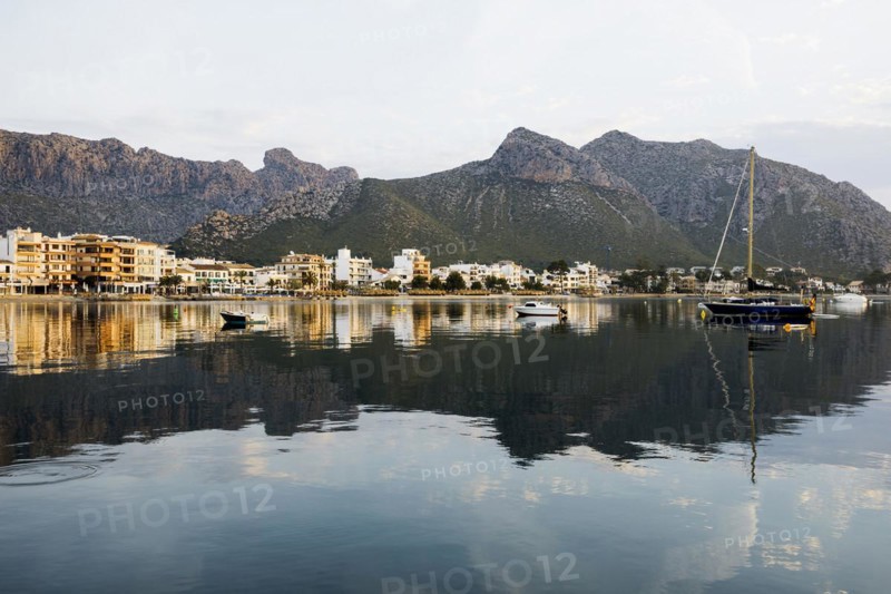 Village by the sea and mountains at sunrise, Port de Pollenca, Serra de Tramuntana, Majorca, Balearic Islands, Spain, Europe