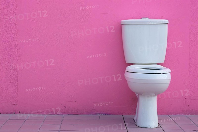 White ceramic toilet in front of pink wall. KI generiert, generiert AI generated