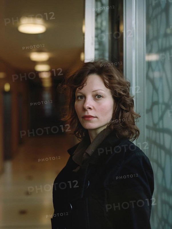 Woman with wavy hair wearing a coat indoors with a natural expression and subtle colors in the background, AI generated