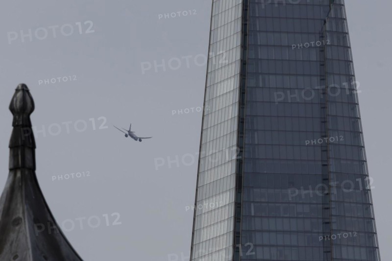 Airbus A319-100 aircraft of British airways in flight over The Shard city skyscraper building, London, England, United Kingdom, Europe