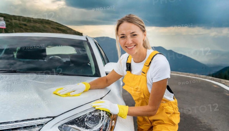 AI generated, A blonde woman washes a car by hand, silver sports car