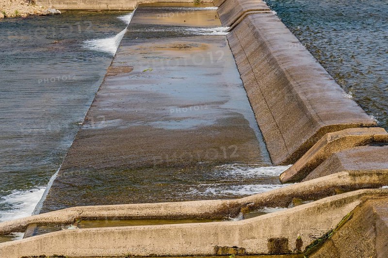 Step-like concrete dam with water cascading down its channels, in South Korea