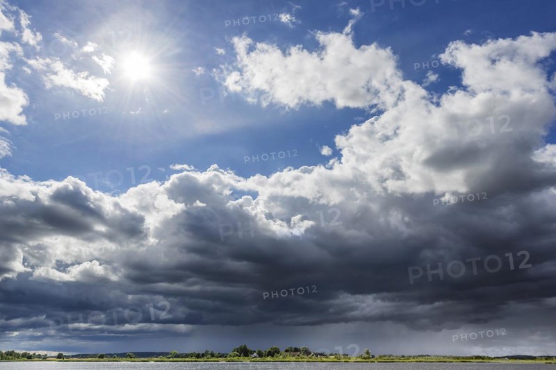 Dramatic changeable weather on the lake with cloudy sky, sun, cloud, light, light mood, atmosphere, play of light, sunbeams, thunderstorm, journey, holiday, boat, landscape, recreation, nature, nautical, seafaring, horizon, water, nobody, lonely, calm, freshwater, Masuria, Poland, Europe