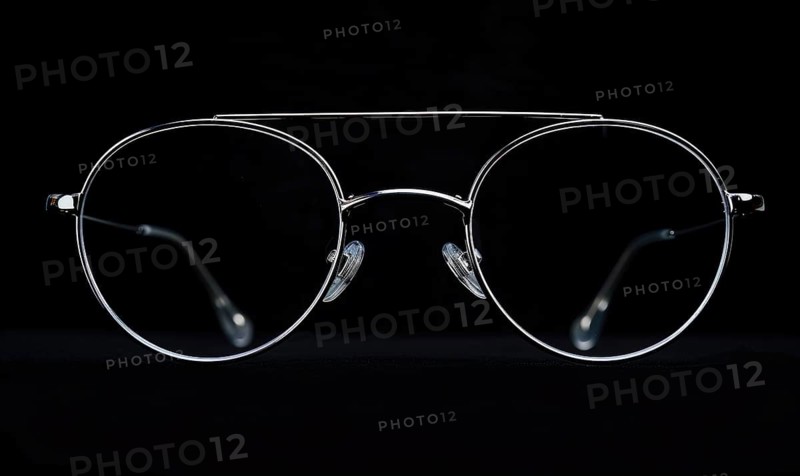 Contrasting silhouette of aviator sunglasses with a white outline on dark background AI generated