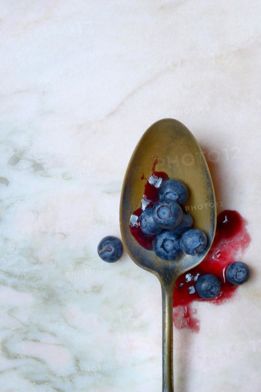 Blueberries and blueberry jam in spoons, blueberry