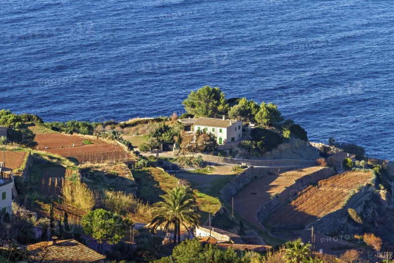 Coastal landscape with a house and terraced fields overlooking the blue sea, Hiking tour from Estellences to Banyalbufar, Mallorca