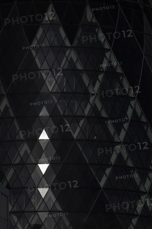 The Gherkin skyscraper building close up of window details with sunlight illuminating three triangle windows, City of London, England, United Kingdom, Europe