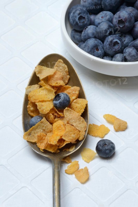 Cornflakes and blueberries in spoon, Breakfast