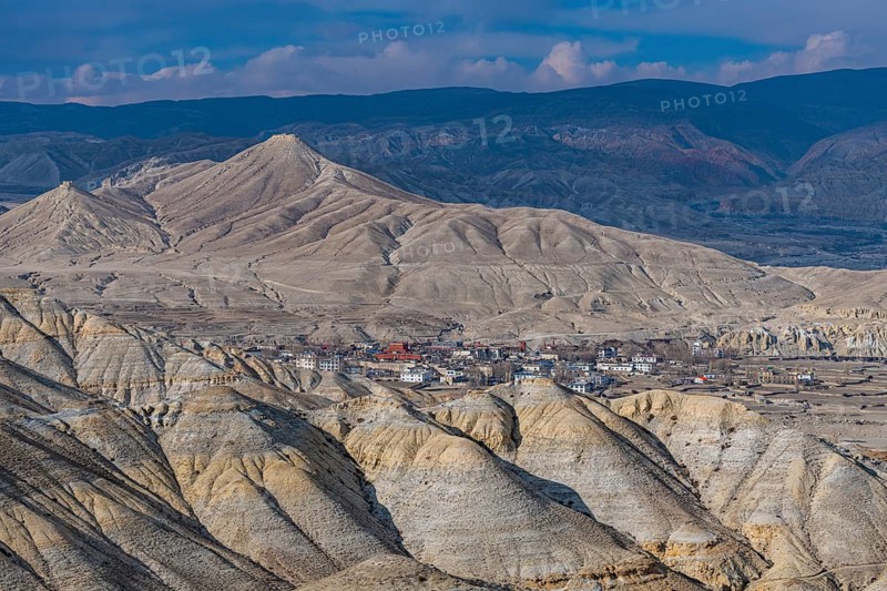 Lo Manthang, capital of Upper Mustang, viewed from a distance amidst a barren desertic landscape, Kingdom of Mustang, Nepal, Asia