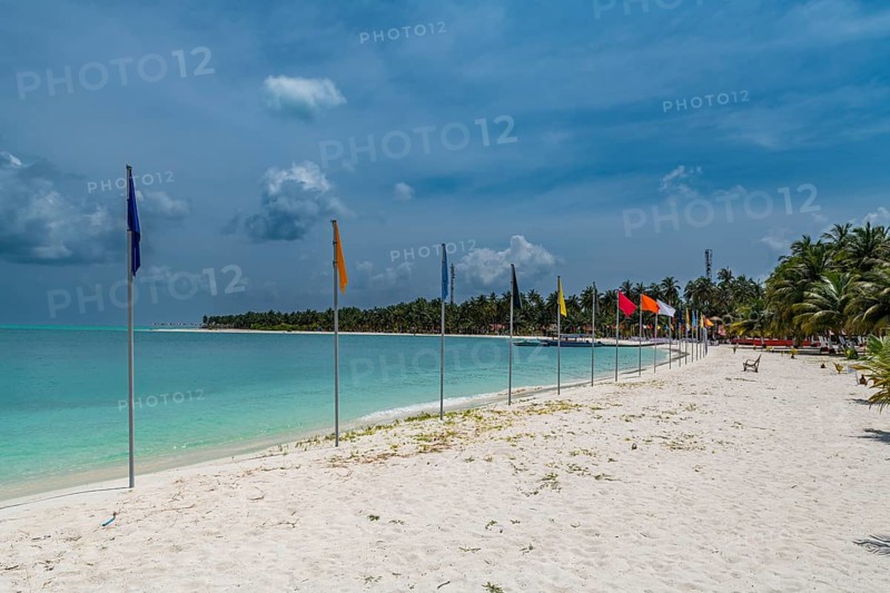White sand beach with many flags, Bangaram island, Lakshadweep archipelago, Union territory of India