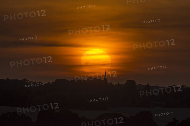 Evening sun veiled by clouds, Schoenberg, Mecklenburg-Vorpommern, Germany, Europe