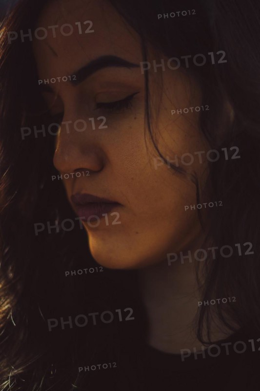Close-up of a woman's face in a moody, introspective ambiance, a complete tool panel in background with bokeh effect, traditional male jobs by Mixed-race latino woman