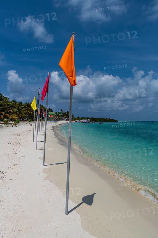 White sand beach with many flags, Bangaram island, Lakshadweep archipelago, Union territory of India