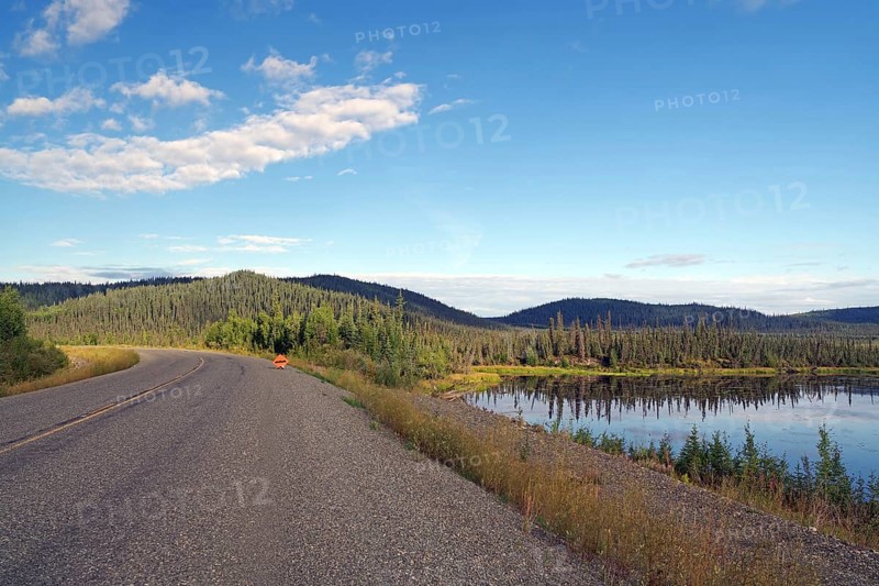 Traffic-free road leads through tranquil lakes and forests, late summer, Alaska Highway, Yukon Territory, Canada, North America