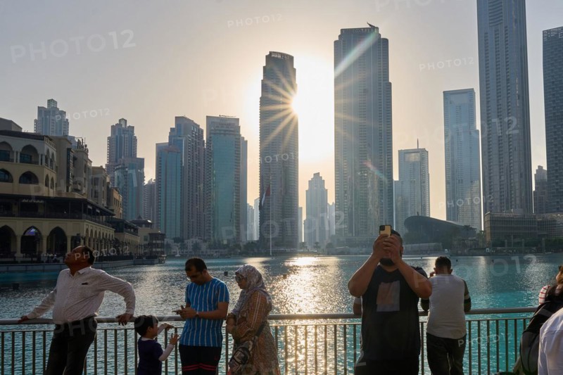 Tourists in front of the skyscraper backdrop at Lake Burj Khalifa. Dubai, United Arab Emirates, Asia