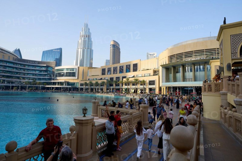 Tourists in front of the skyscraper backdrop at Lake Burj Khalifa. Dubai, United Arab Emirates, Asia