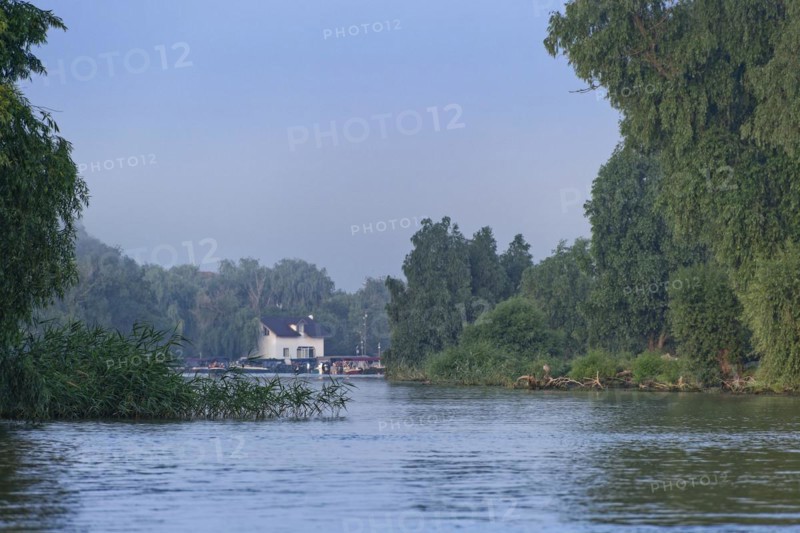 A slightly hazy morning by the water in the UNESCO Danube Delta Biosphere Reserve. Munghiol, Tulcea, Romania, Europe