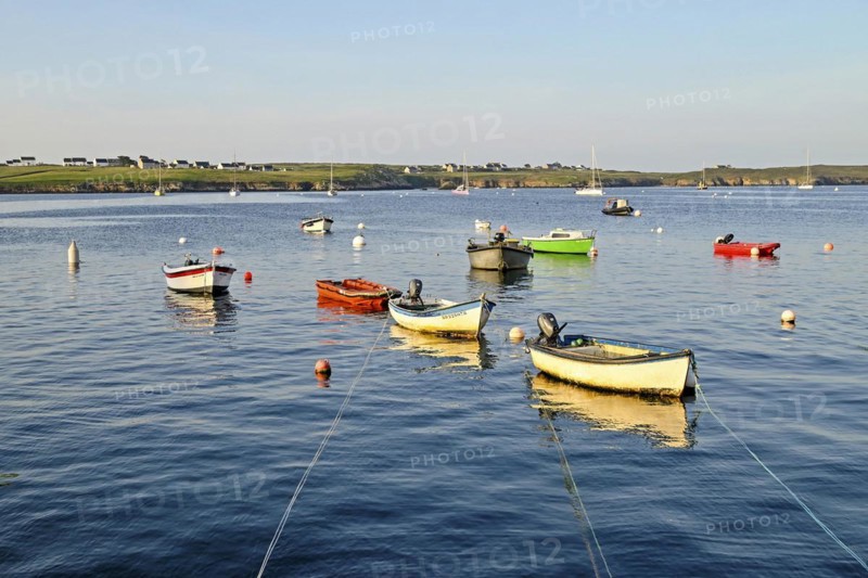 Boats on the blue waters of a bay, Ouessant Island, Finistere, Brittany, France, Europe