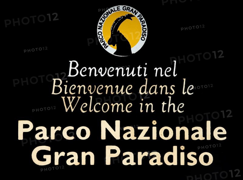 Wooden welcoming board with logo of the Gran Paradiso National Park in the Graian Alps, Italy, Europe