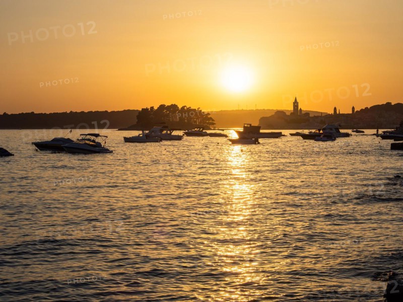 Boats anchoring in a bay, silhouette of a church tower, sunset over Rab, town of Rab, island of Rab, Kvarner Gulf Bay, Croatia, Europe