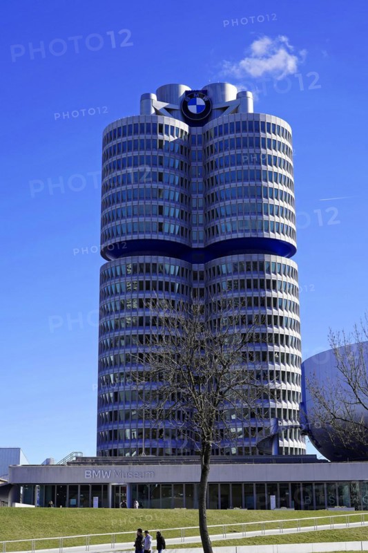 BMW main building, known as the 'four-cylinder', against a clear sky with trees in the foreground, BMW WELT, Munich, Germany, Europe