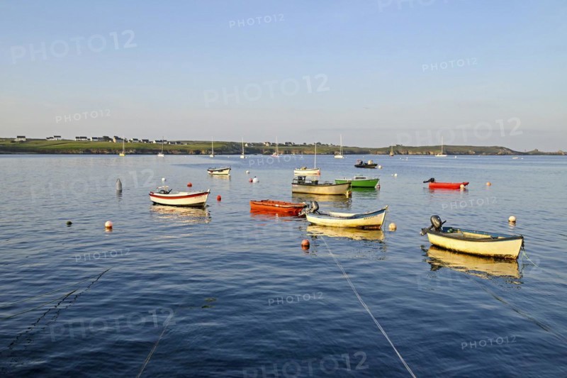 Boats on the blue waters of a bay, Ouessant Island, Finistere, Brittany, France, Europe