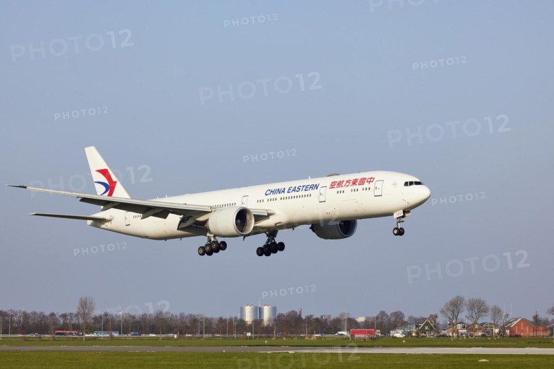 China Eastern Airlines Boeing 777-39P (ER) with registration B-2023 approaching the Polderbaan, Amsterdam Schiphol Airport in Vijfhuizen, municipality of Haarlemmermeer, Noord-Holland, Netherlands