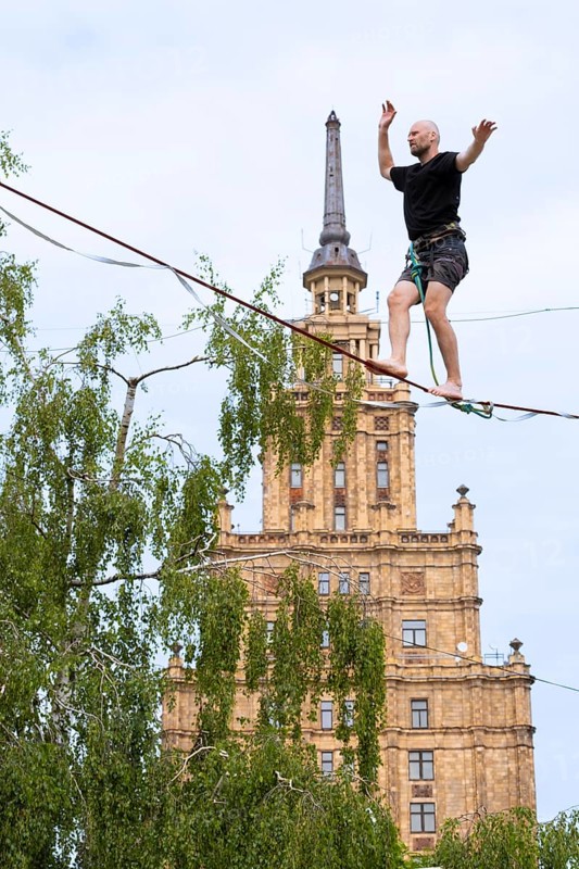 Riga. Alternative cultural centre near the Latvian Academy of Science. Tightrope walker on the slackline, Riga, Latvia, Europe