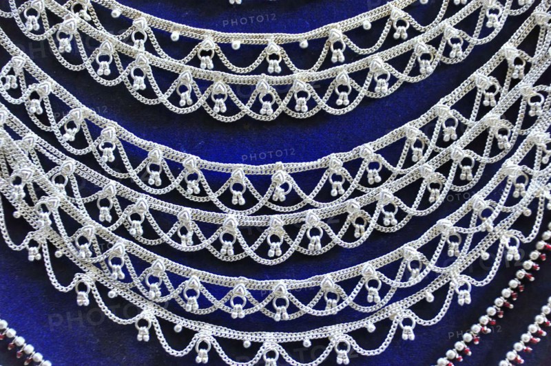 Silver jewellery necklaces with detailed patterns on a dark background, Varanasi, Uttar Pradesh, India, Asia