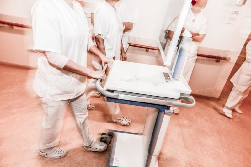 Nurses and care staff walk down a corridor in a hospital in Berlin with the digital patient file, 25/01/2019