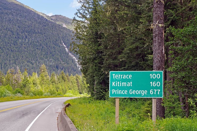 Road sign with distances on the Yellowhead Highway, no traffic, wilderness, Terrace, Kitimat, Prince George, British Columbia, Canada, North America