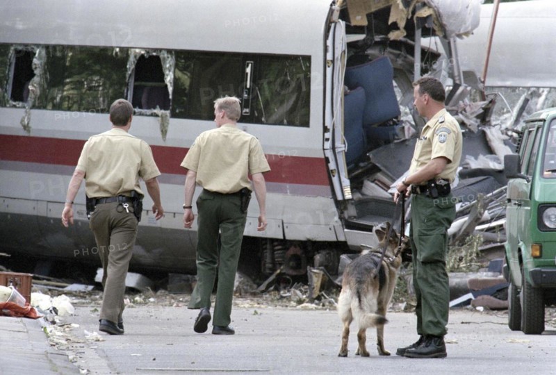 Police officers stand next to a destroyed ICE train carriage on 6 June 1998 in Eschede. 102 people died in the worst Deutsche Bahn train accident