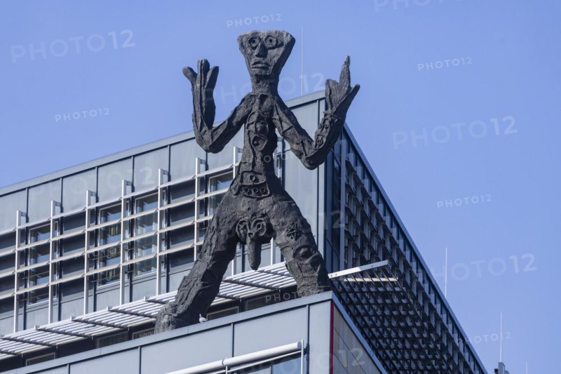 On the acute-angled corner of the building at the junction of Maxstrasse and Ostra-Allee stands a four-metre bronze sculpture of a stick figure created by A. R. Penck, Dresden, Saxony, Germany, Europe