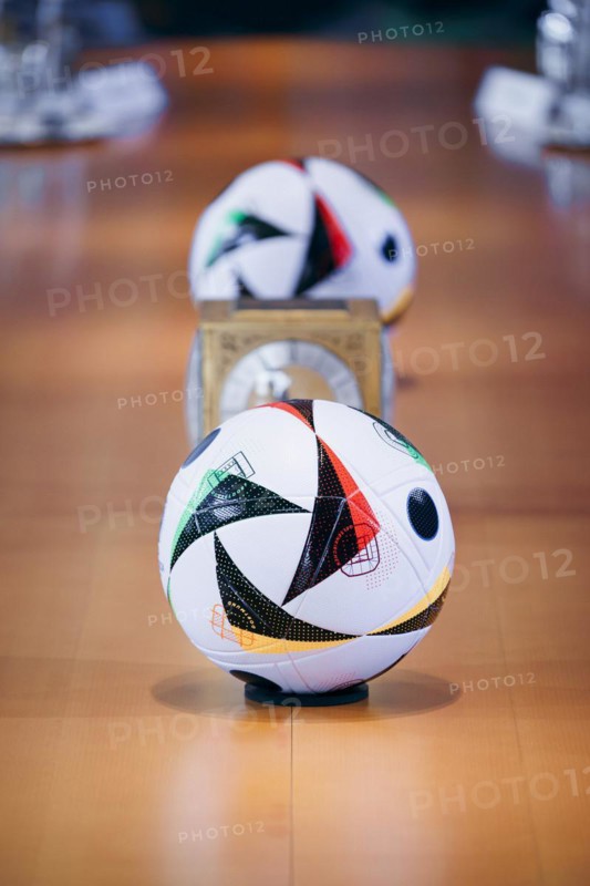Two footballs lie on the cabinet table during a cabinet meeting at the Federal Chancellery in Berlin, 06/03/2024