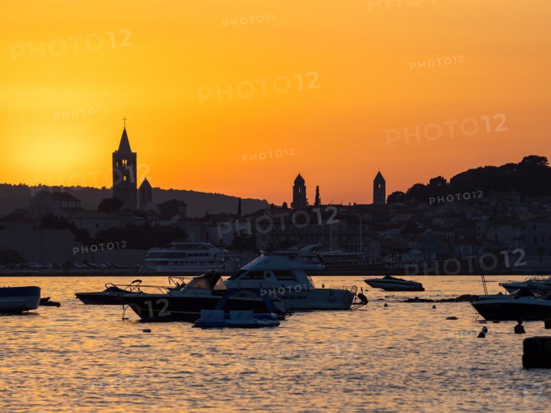 Boats anchoring in a bay, silhouette of church towers, evening mood after sunset over Rab, town of Rab, island of Rab, Kvarner Gulf Bay, Croatia, Europe