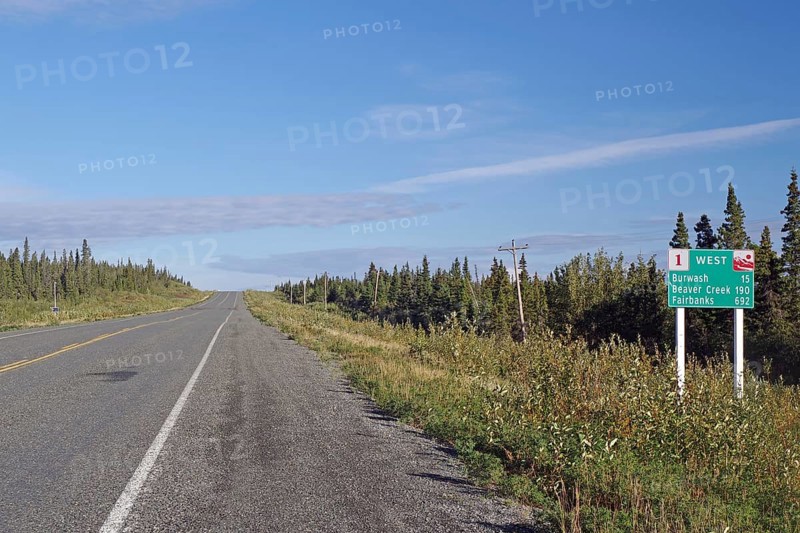 Road leads as endless grades through wilderness, no traffic and one traffic sign, Alaska Highway, Yukon Territory, Canada, North America