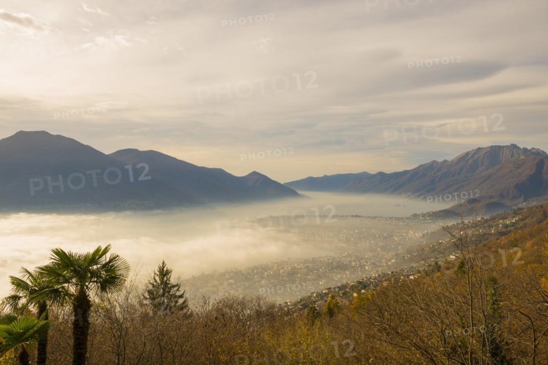 Sea of Fog and Mountain Valley over Locarno in Ticino, Switzerland, Europe
