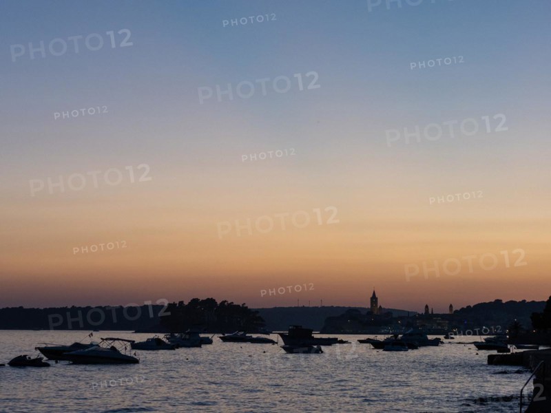 Boats anchoring in a bay, church towers, evening mood after sunset over Rab, town of Rab, island of Rab, Kvarner Gulf Bay, Croatia, Europe