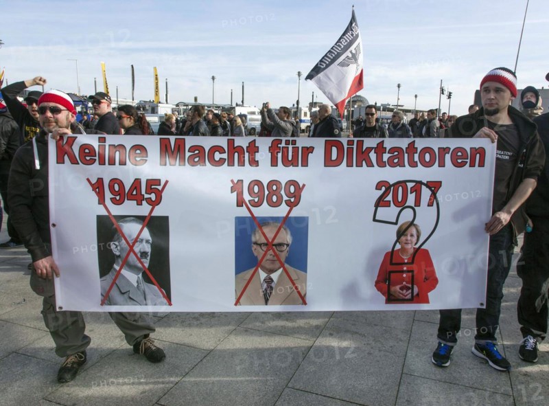 Participants in the Merkel must go demo. Demonstration by right-wing populist and right-wing extremist participants, including supporters of the NPD, Pegida, Reichsbuerger, hooligans, Landsmannschaften and Identitarians, Berlin, 4 March 2017