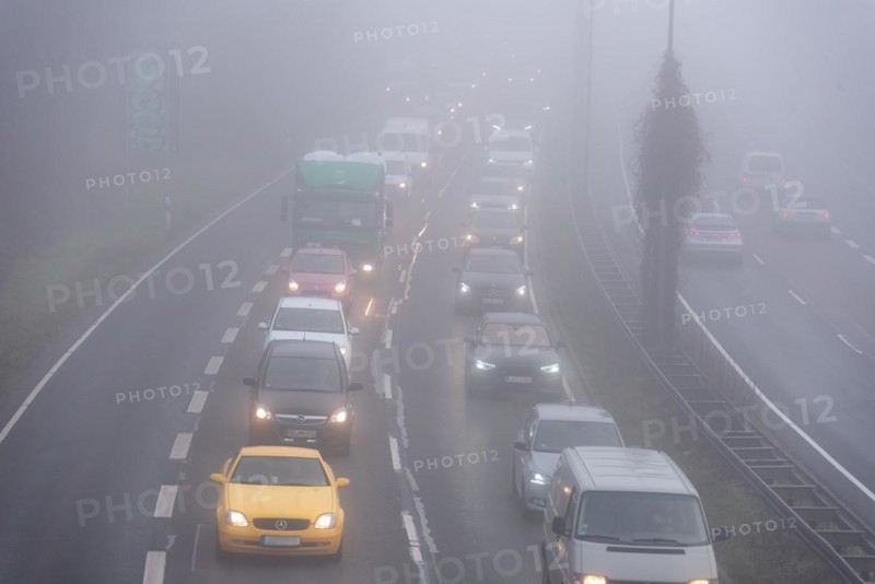 Cars driving on a foggy road with poor visibility in the grey daylight, Magdeburg, Saxony-Anhalt, Germany, Europe