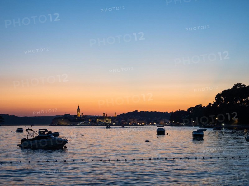 Boats anchoring in a bay, church towers, sunset over Rab, town of Rab, island of Rab, Kvarner Gulf Bay, Croatia, Europe