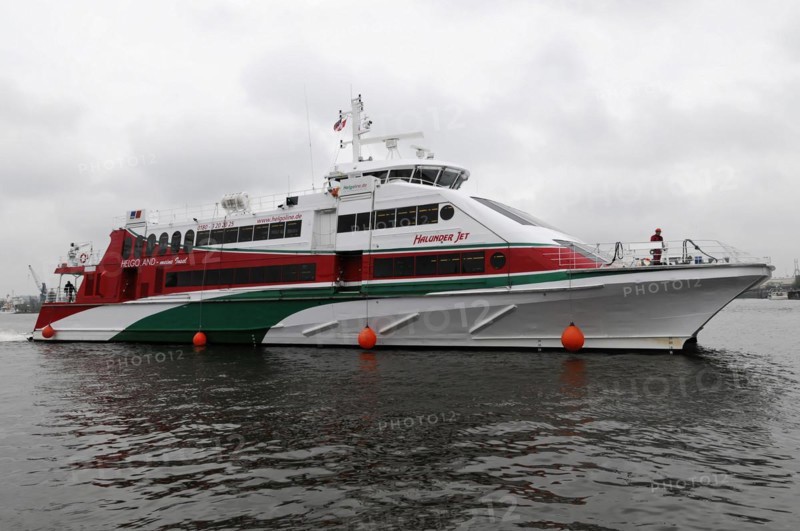 The red and white catamaran 'Halunder Jet' tied between two buoys on the water, Hamburg, Hanseatic City of Hamburg, Germany, Europe
