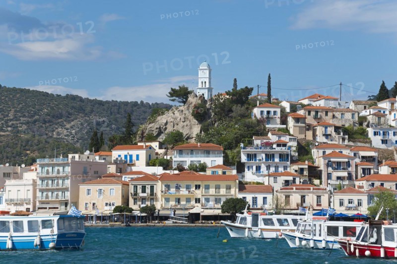 View of an idyllic Mediterranean coastal town with harbour, whitewashed houses and blue sky, view from Galatas, Argolis, to Poros, Poros Island, Saronic Islands, Peloponnese, Greece, Europe